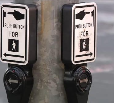 Watch: Crosswalk buttons hacked to play hoax Musk, Zuckerberg recordings